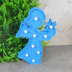 LED angel night light creating a soft, romantic ambiance in a beautifully decorated room.