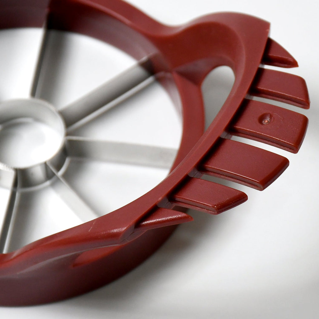 Perfectly sliced apple pieces arranged on a plate, with the core neatly removed by the apple slicer.