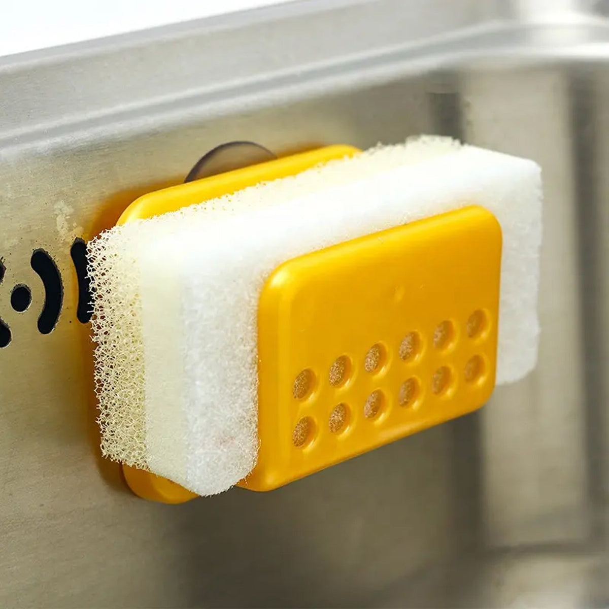 Self-adhesive kitchen sink organizer with sponge and soap.