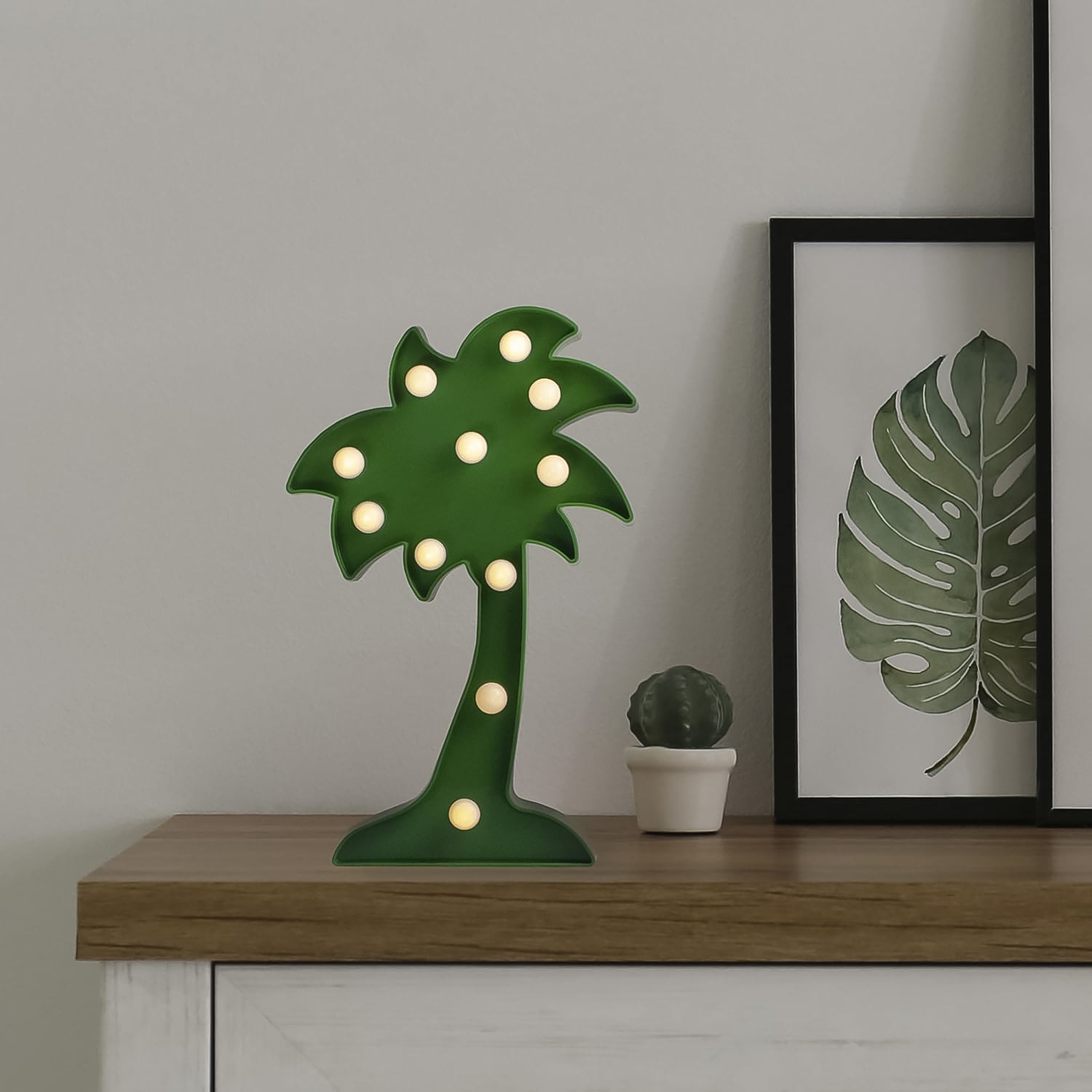 The Coconut Tree LED Lamp shown in a lifestyle shot, enhancing a modern bedroom's decor.