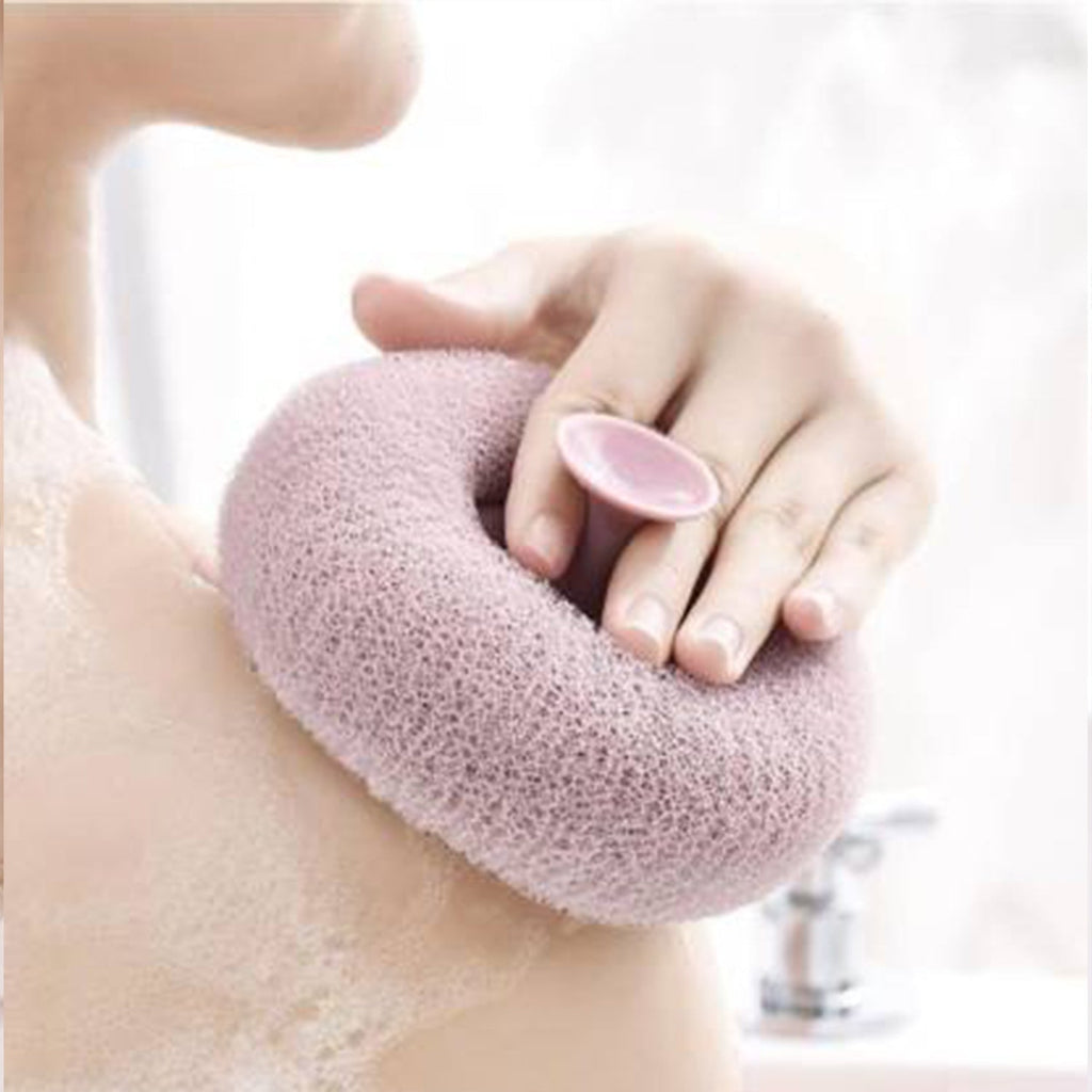 A hand holding the flower-shaped bath sponge during a refreshing shower.