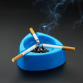 Sky blue plastic ashtray with wide bowl and triple cigarette holder slots