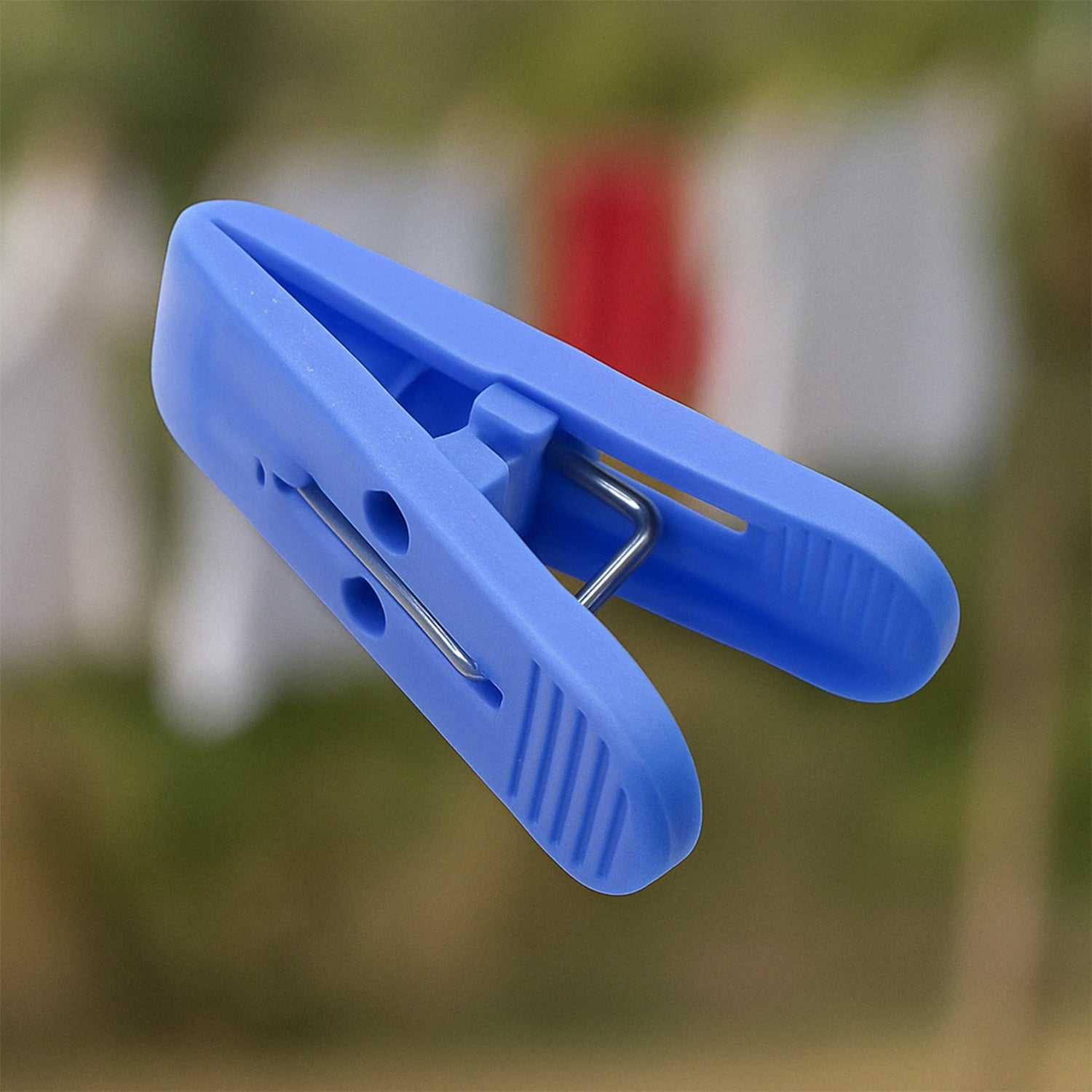 Multicolor plastic cloth drying clips securely holding laundry on a clothesline.