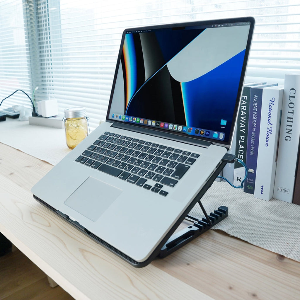 Laptop cooling pad with a gaming laptop placed on top, showing effective cooling in use.