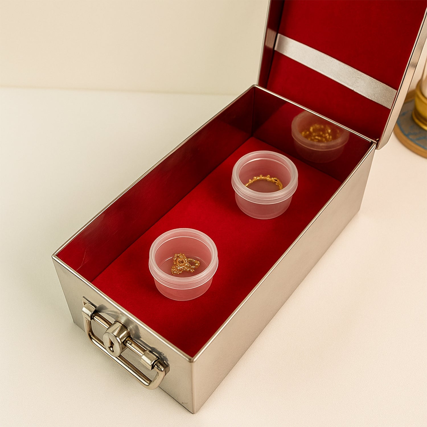 Full front view of the stainless steel Jewellery Storage Box with its luxurious red velvet interior.