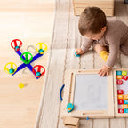 A child aiming a ball into one of the five baskets in the basketball toy set.