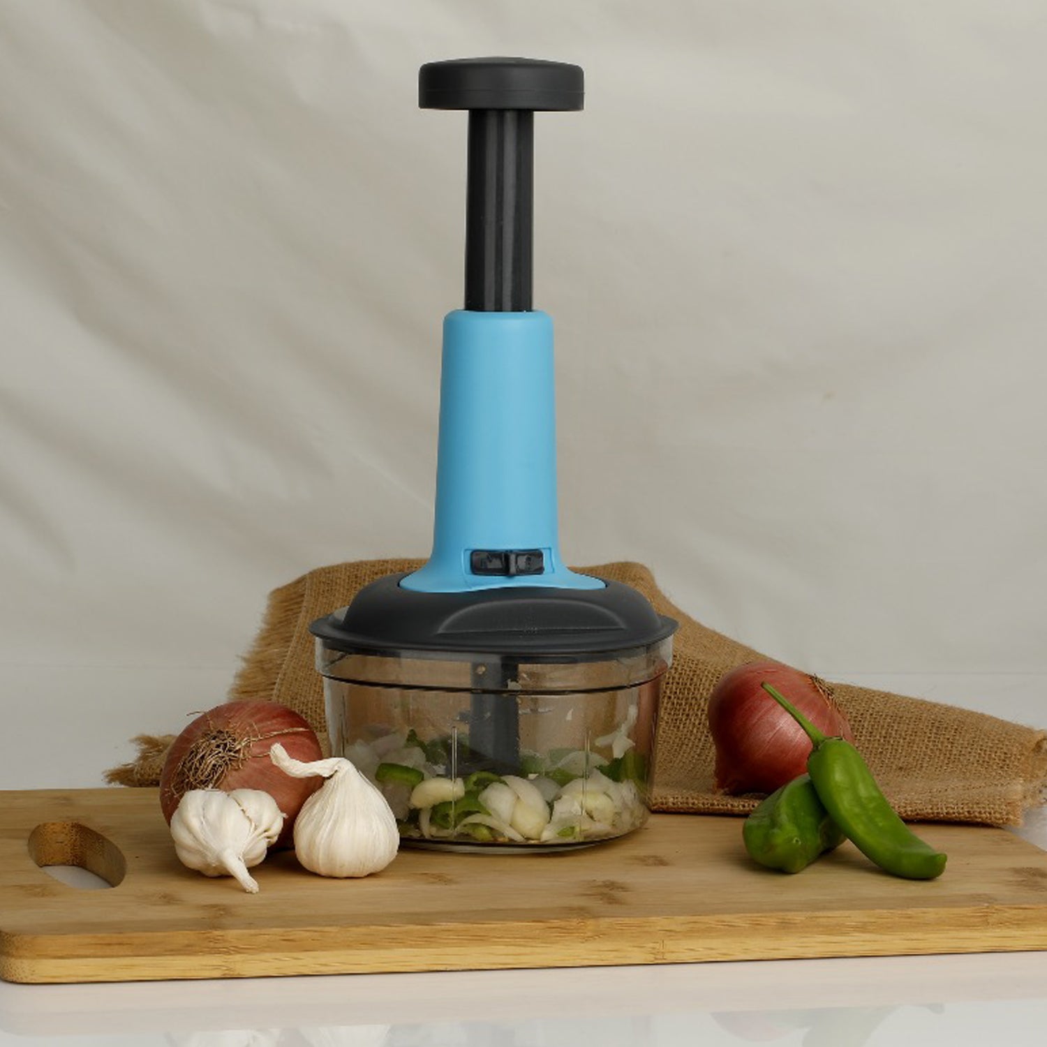 Detailed view of the sharp, triple stainless steel blades inside the food chopper for precision.
