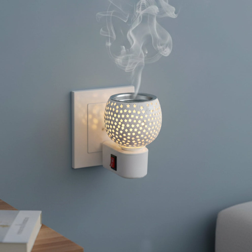 Star cut glass aroma diffuser plugged into electrical wall socket