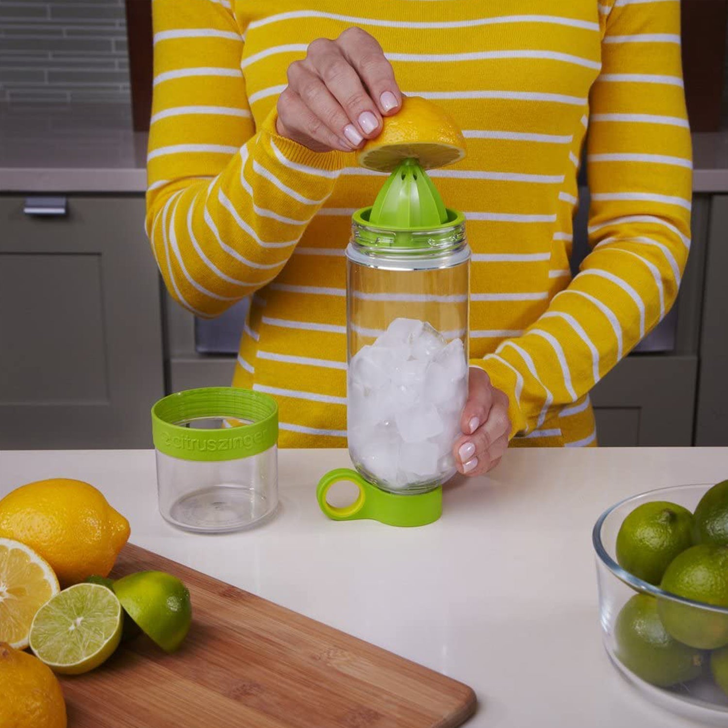 Demonstration of the juice maker bottle's removable bottom cap for easy citrus juicing and cleaning.