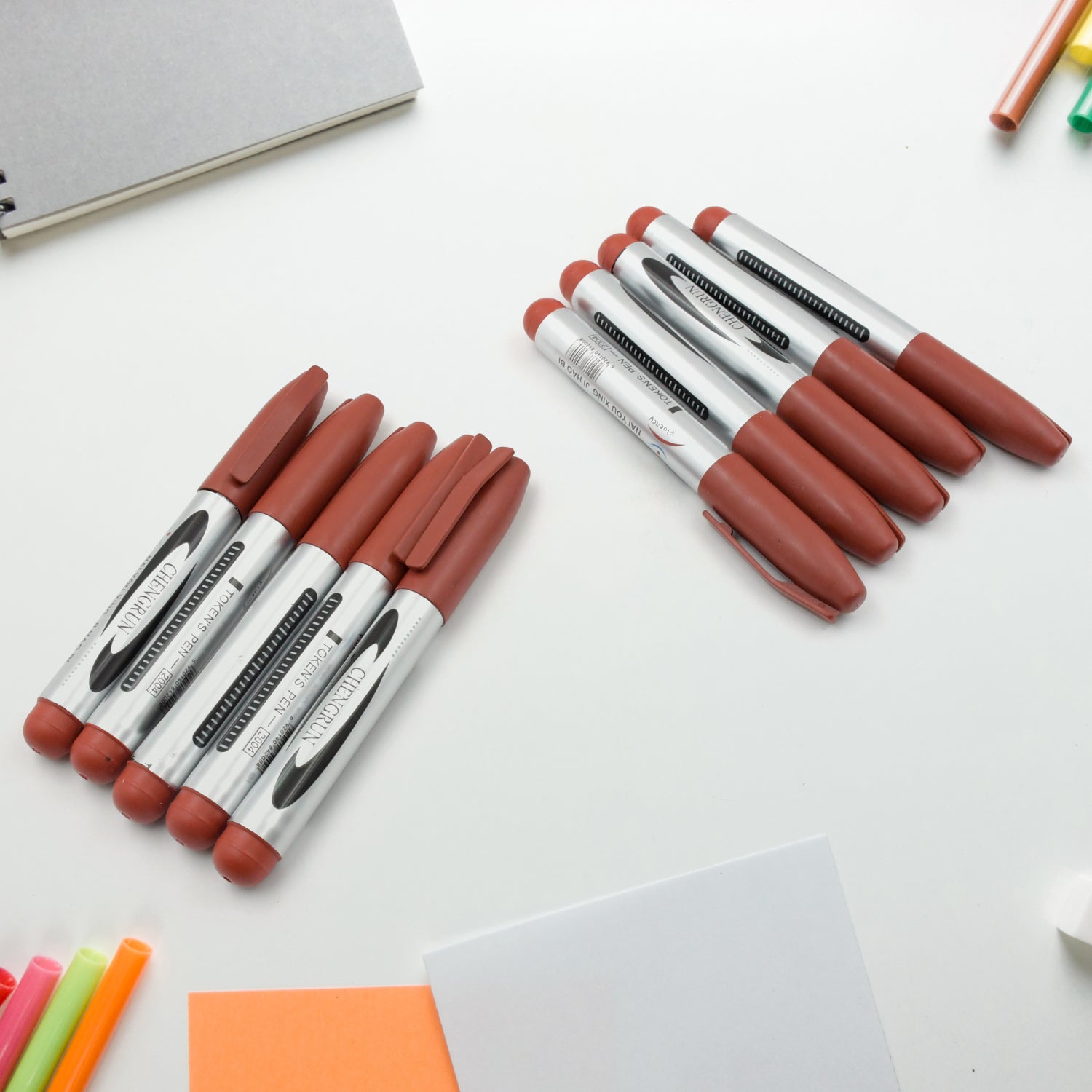 A 10-piece set of maroon permanent markers displayed in a box.