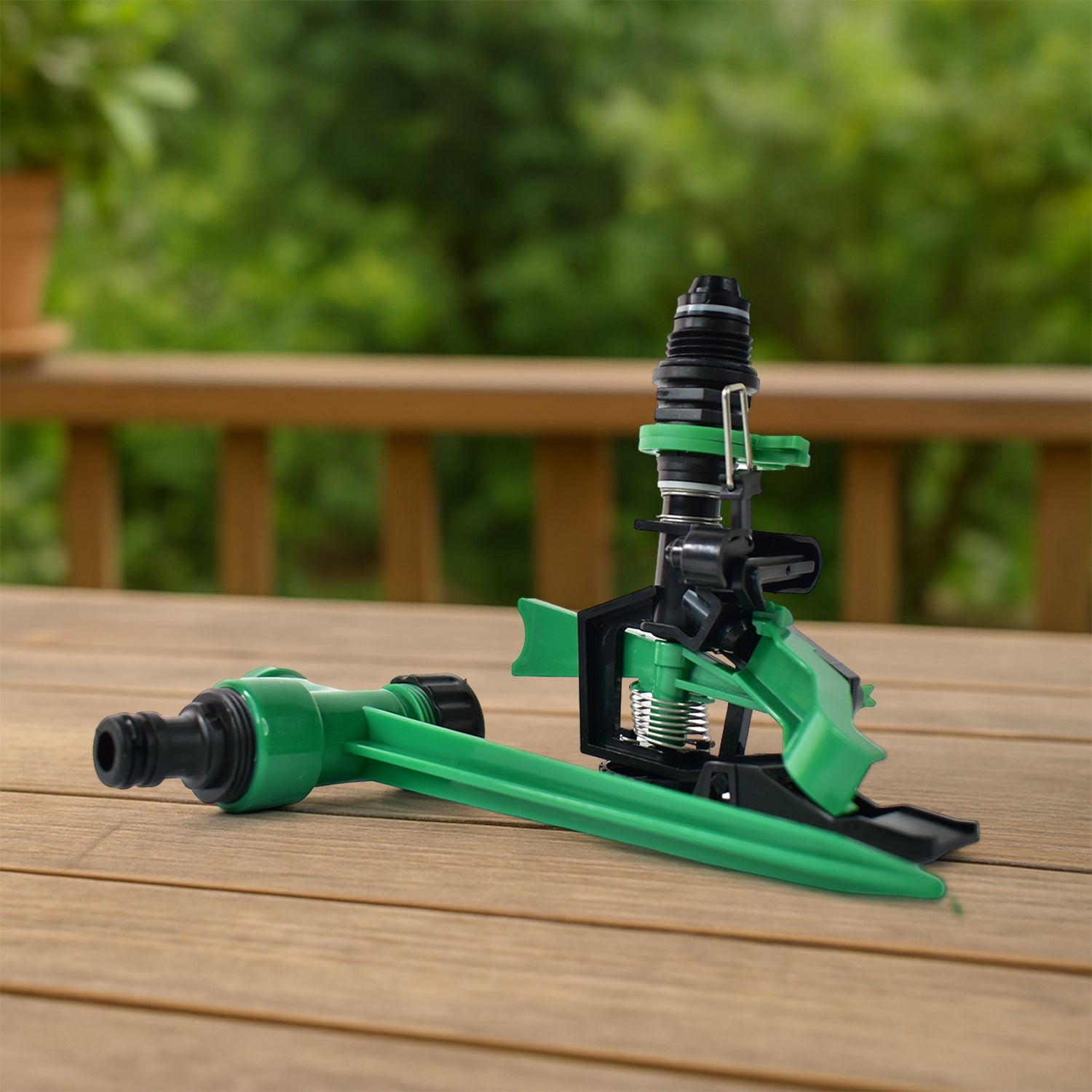 Water spray from rotating garden sprinkler installed in green lawn