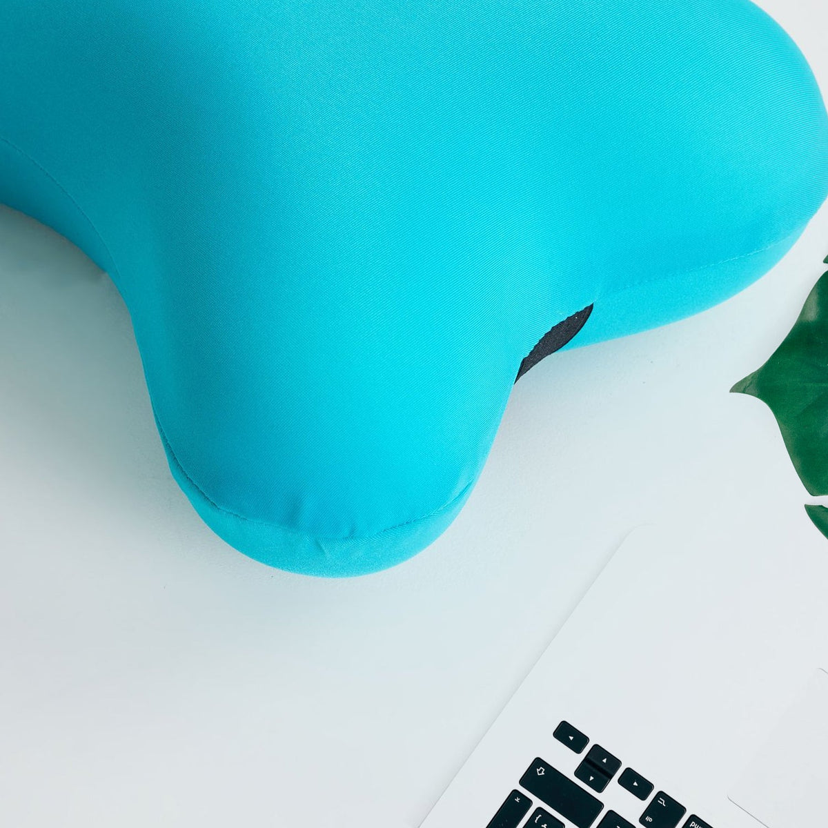 Detailed view of the soft microbead neck pillow's texture.