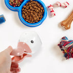 Pet food scoop and sealing clip placed on kitchen countertop