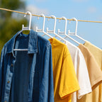 White plastic clothes hanger in practical use inside a closet