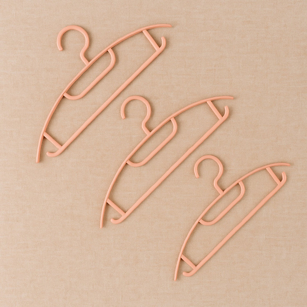 Ganesh brand plastic cloth hangers showcasing smooth edges and sturdy build
