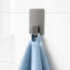 Pack of multiple stick-on adhesive wall hooks
