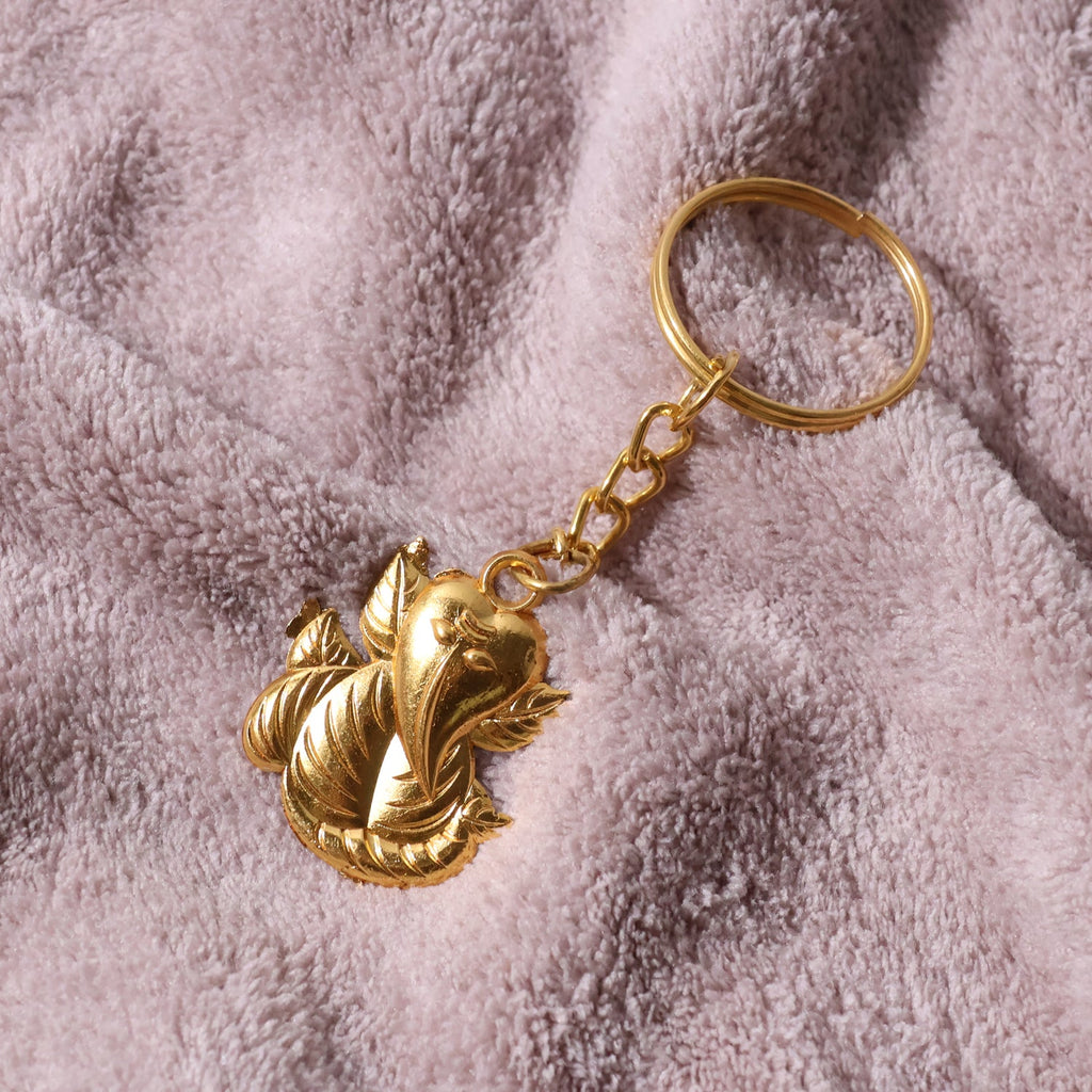 Golden Ganesh metal keychain laying flat with chain and ring