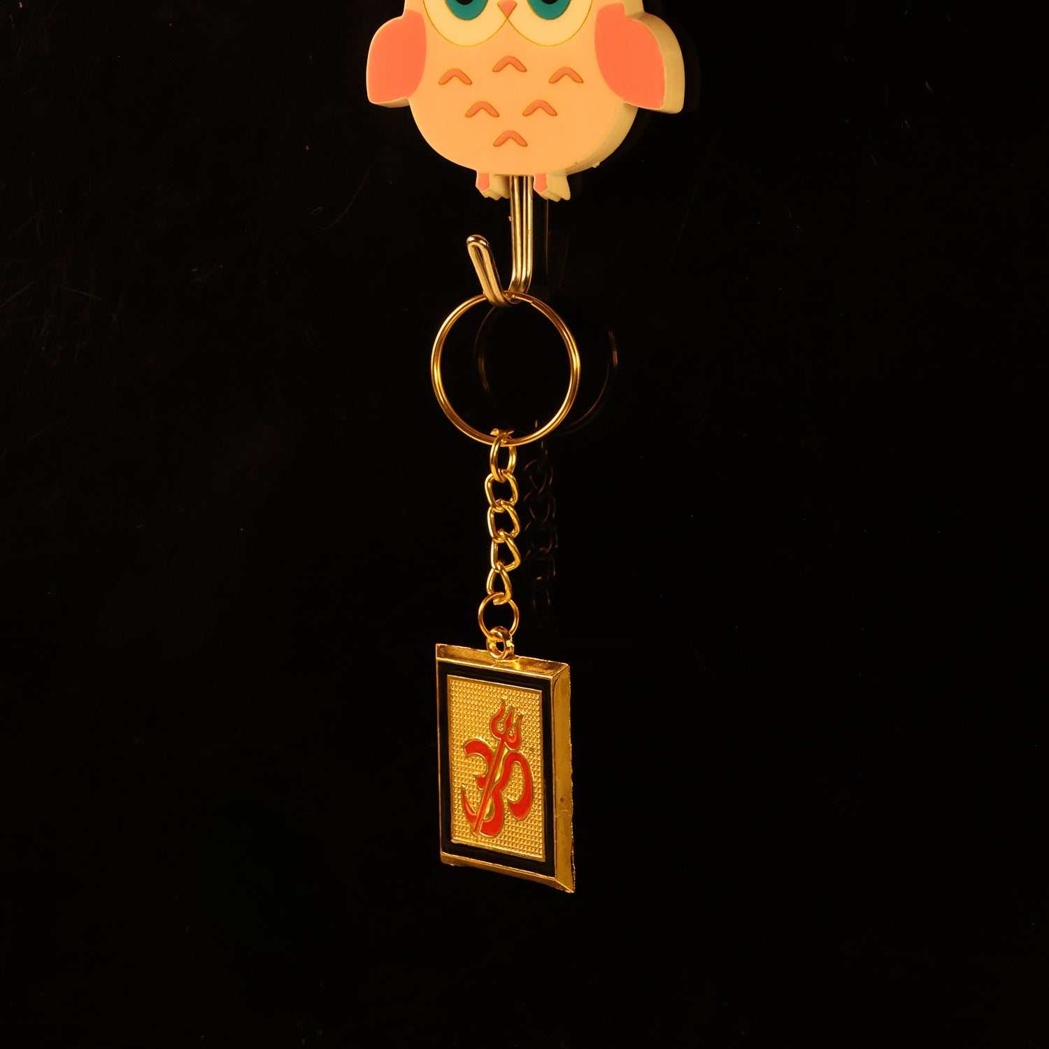 Zoomed-in view showing ornate Om Trishul keychain in durable metal