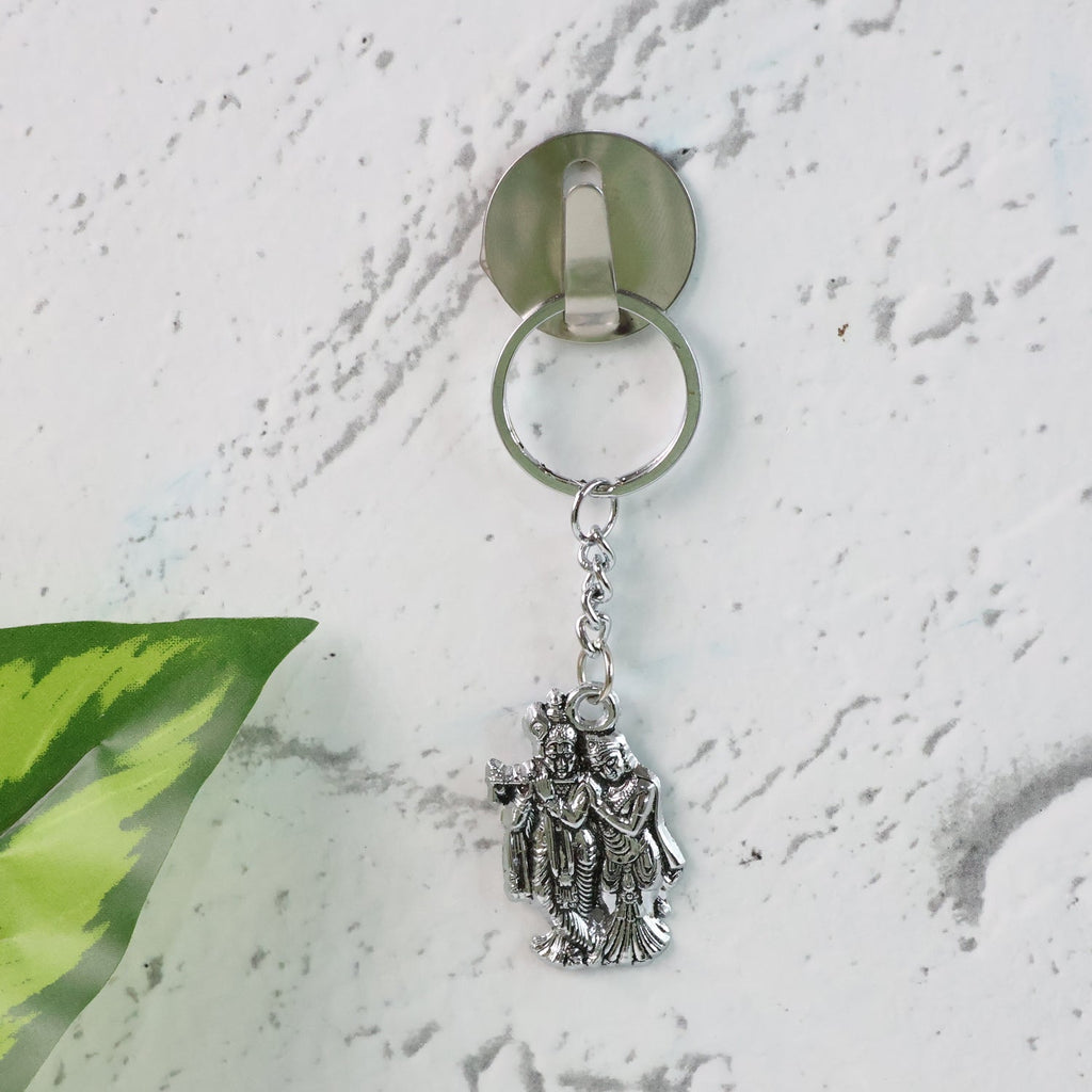 Radha Krishna metal keychain displayed on white background