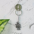 Radha Krishna metal keychain displayed on white background
