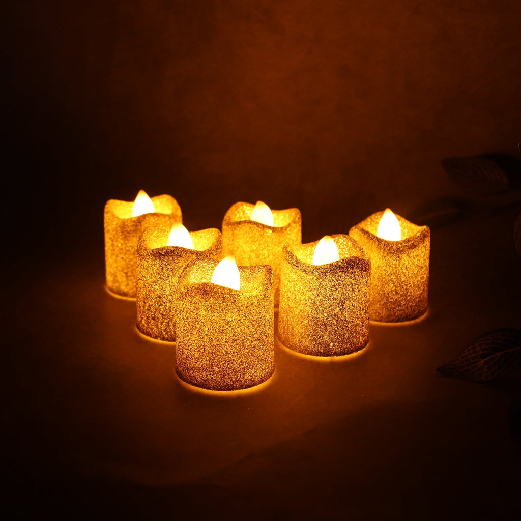 Close up of LED tealight candle emitting warm flickering light and glitter