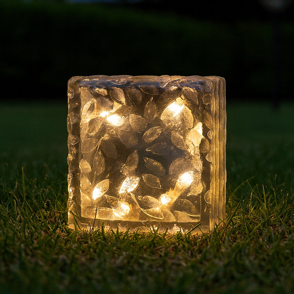 Three solar garden lights arranged artistically on a stone path.