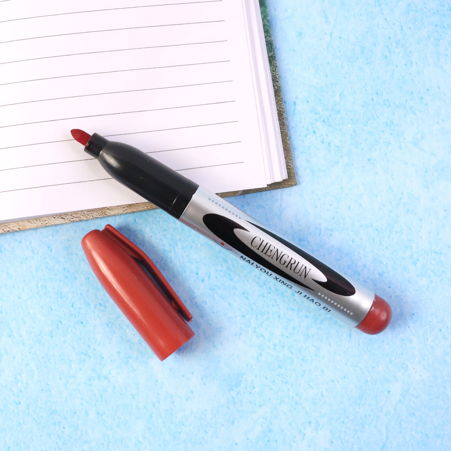 Multi-surface permanent marker pen in maroon color
