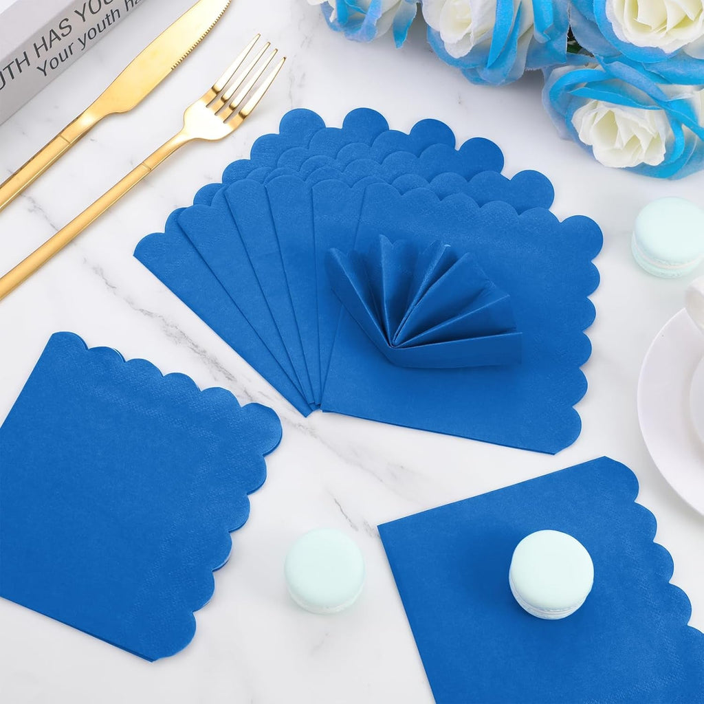 Folded royal blue scalloped paper napkin for elegant presentation