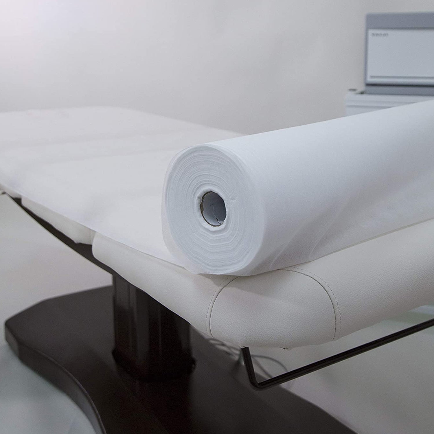 Close-up view of medical couch paper tissue roll with perforated sheets