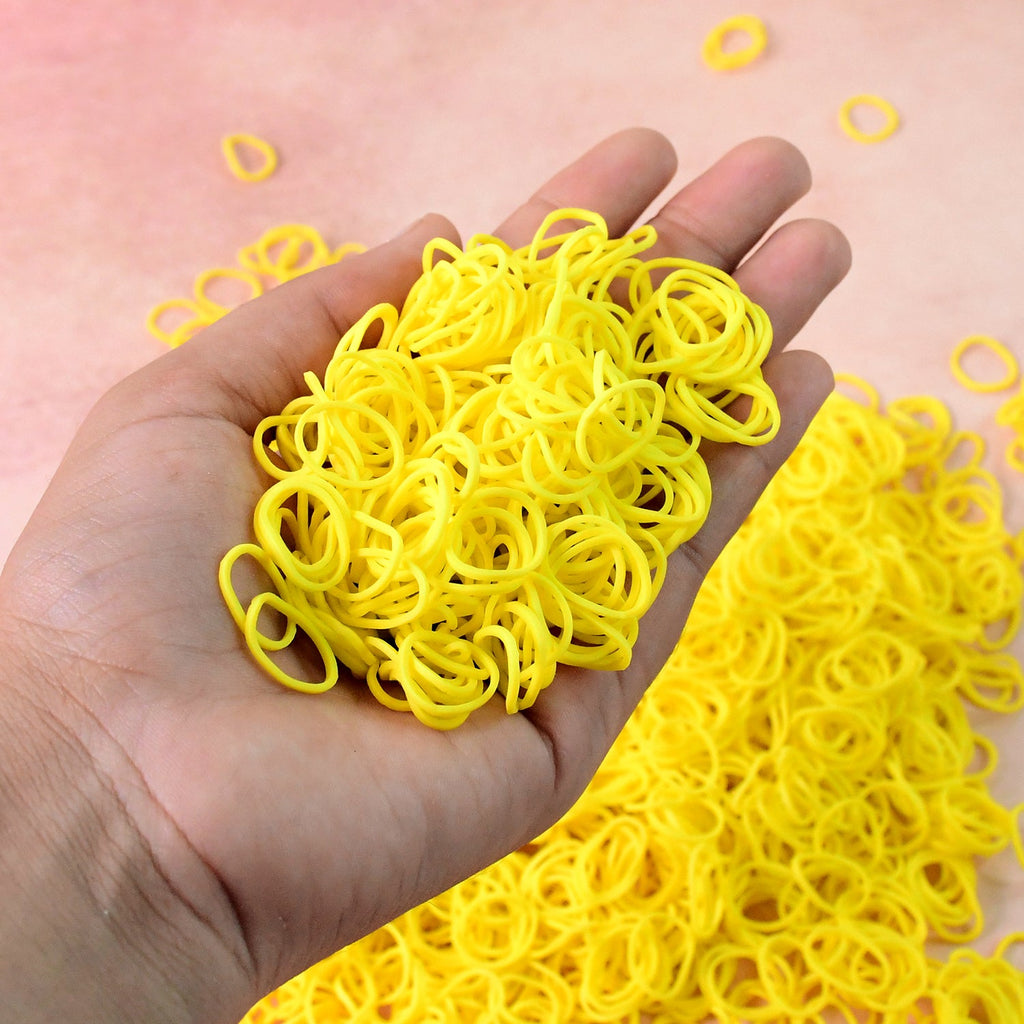 Bright orange elastic rubber bands bundled together