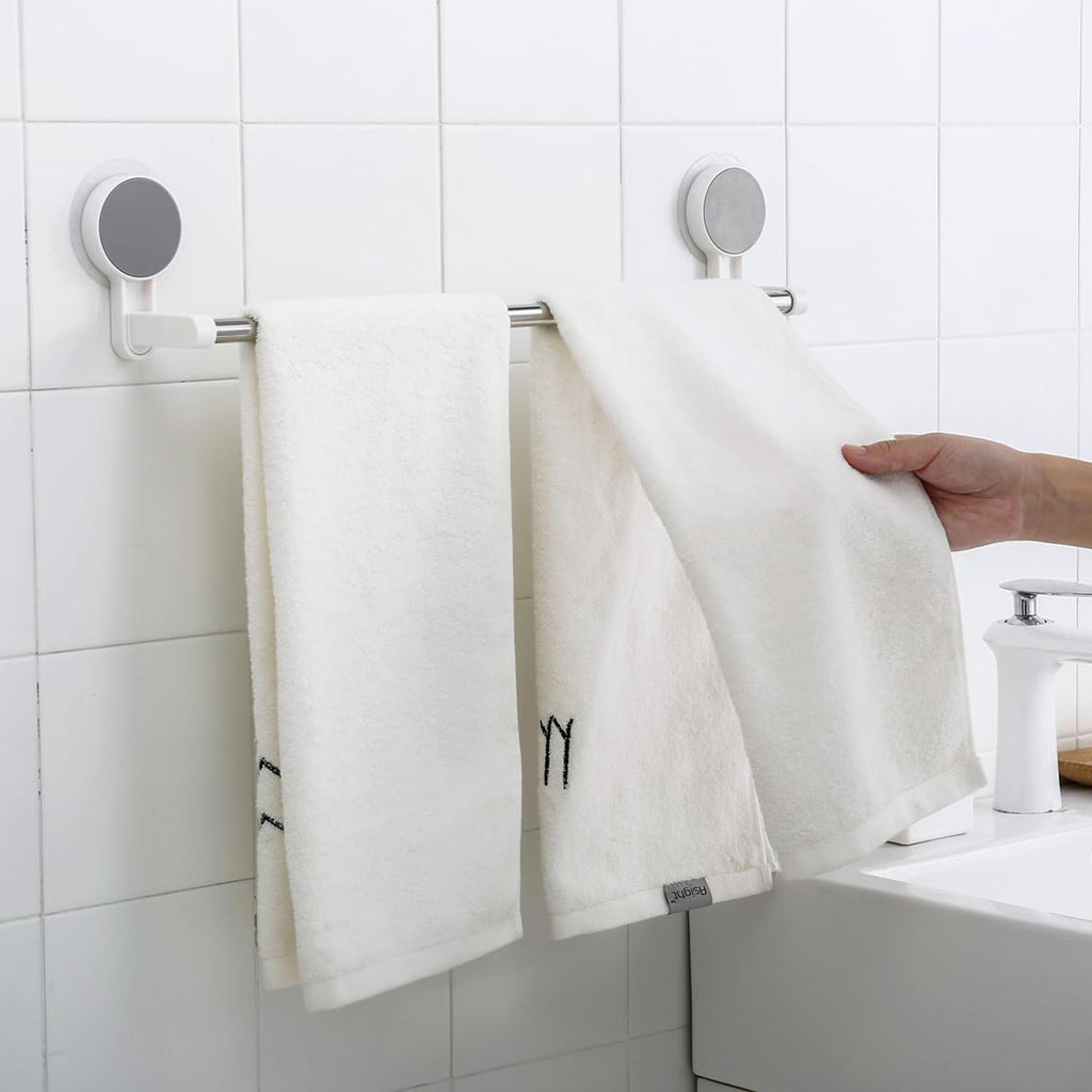 Towel rack bar installed on bathroom wall using adhesive mount