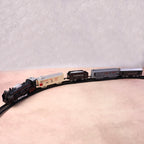 Battery powered toy train set pieces showing engine and carriages