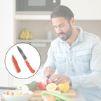Close-up of a sharp ceramic kitchen knife blade with its safety cover removed.