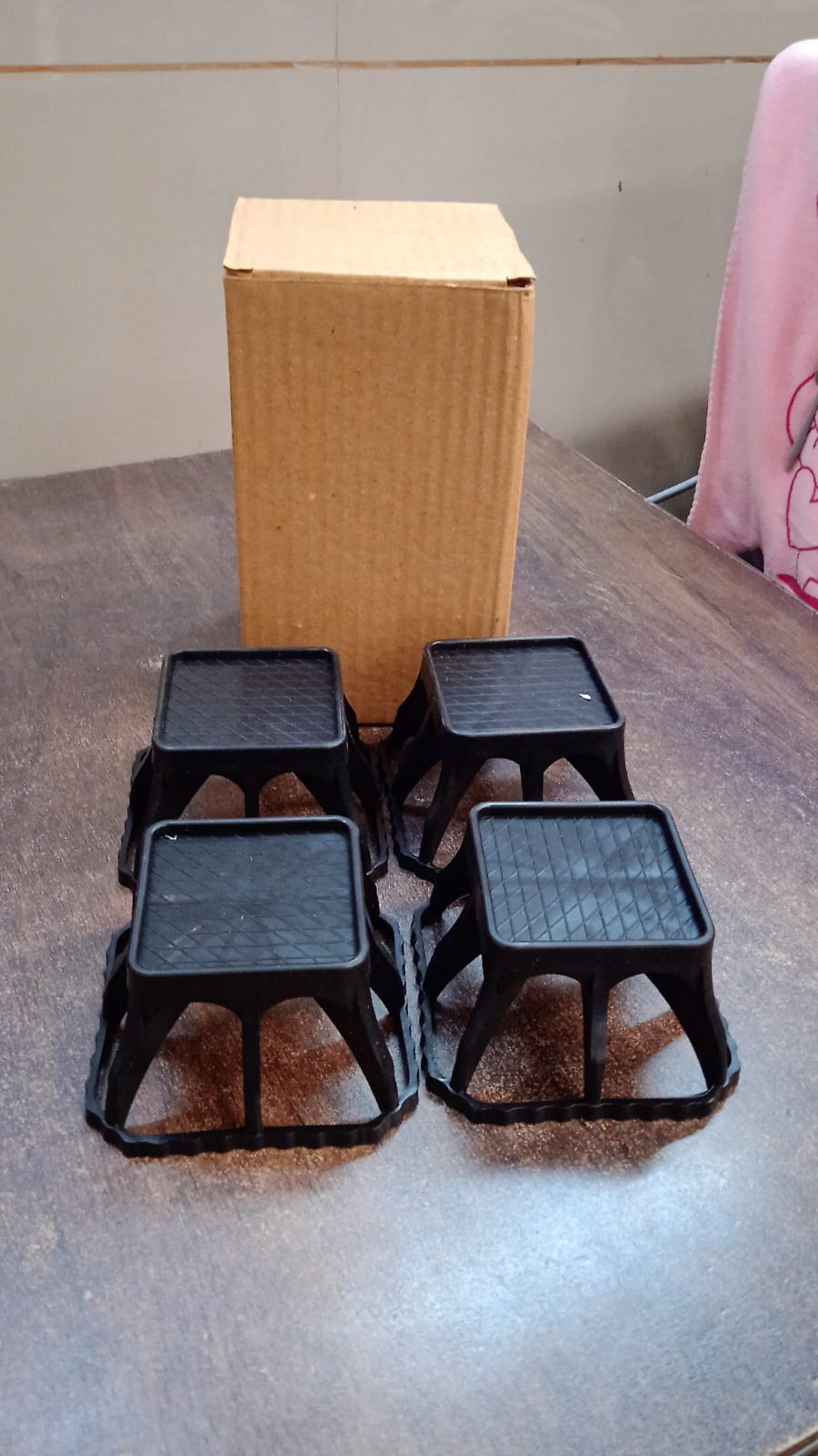 Plastic washing machine stand set placed in laundry room for appliance elevation