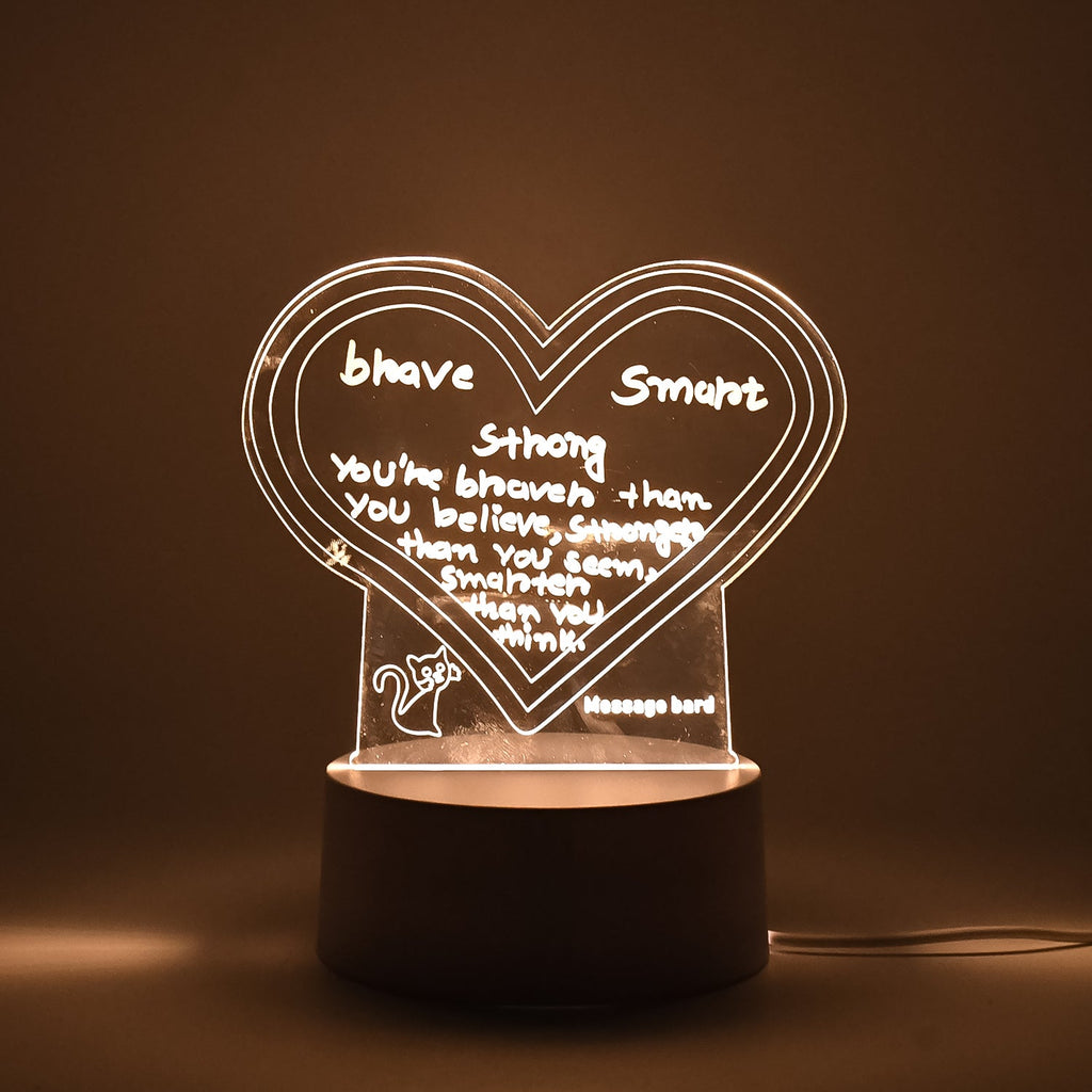 Workspace decorated with glowing 3D acrylic visualization lamp and drawing