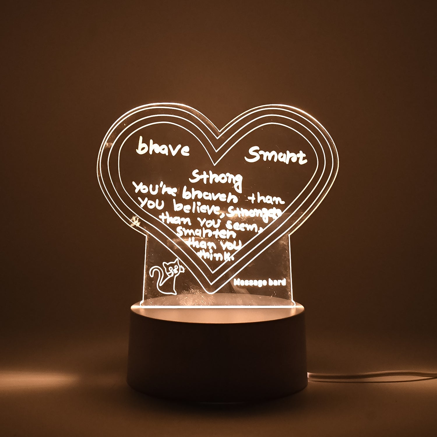 Workspace decorated with glowing 3D acrylic visualization lamp and drawing