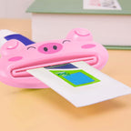 Cute animal-shaped toothpaste tube squeezer on a bathroom counter.
