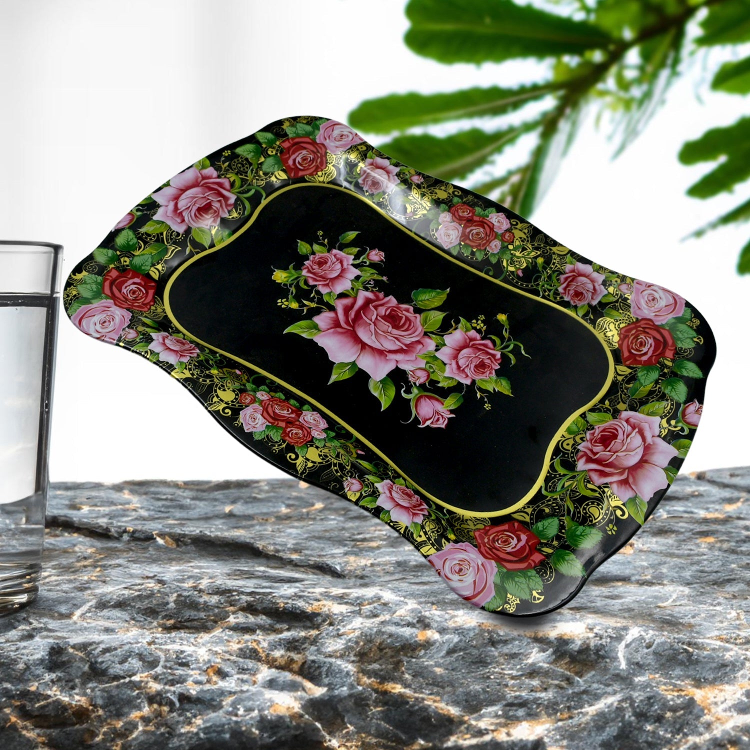 Floral stainless steel serving tray on a dining table, showcasing its aesthetic appeal.