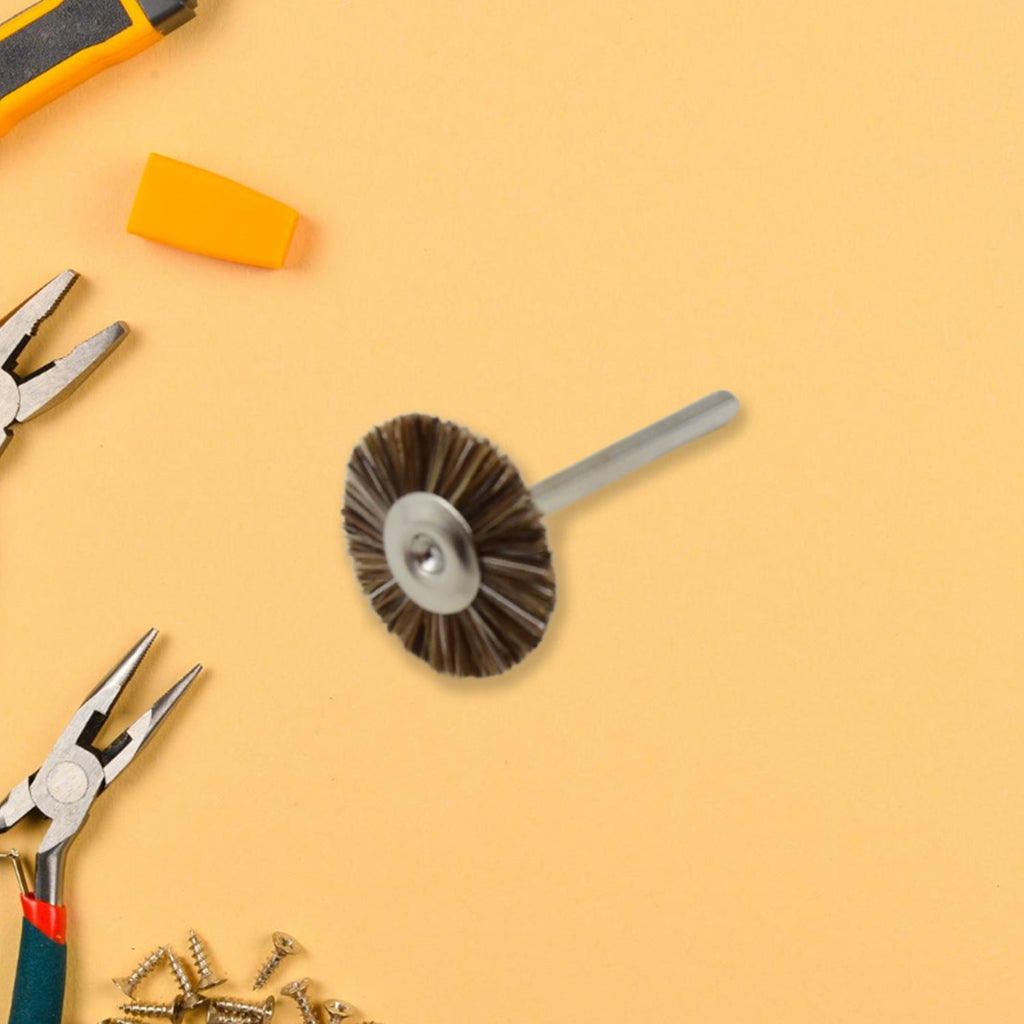 A shank-mounted brass wire brush, ideal as a drill attachment for metal grinding.
