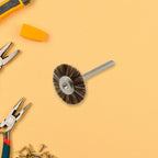 A shank-mounted brass wire brush, ideal as a drill attachment for metal grinding.