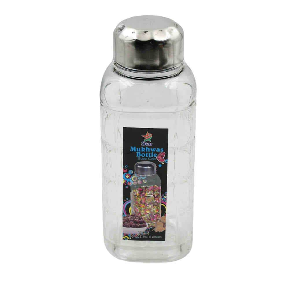 Transparent mukhwas bottle sitting on a kitchen counter with snacks