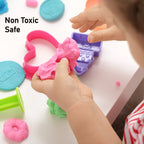 Kinetic sand in a clear container with various molds, ready for creative play.