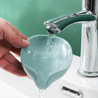 Compact self draining soap box for a bathroom sink.