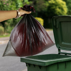 Garbage bag roll being easily dispensed from its compact packaging.