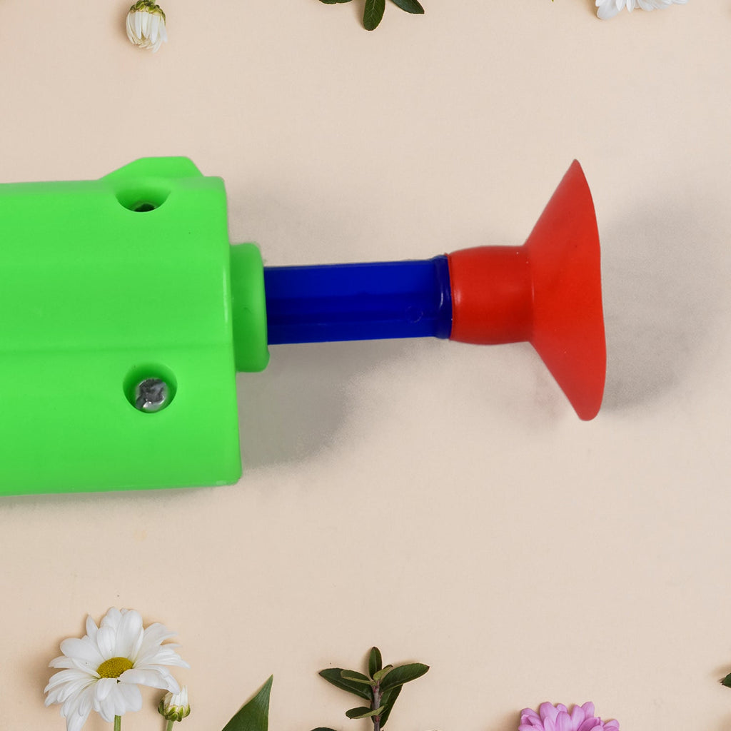 Child's hand holding the toy gun, illustrating how to shoot soft darts safely.