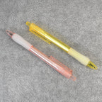 A pair of CustoPen ballpoint pens displayed with essential office stationery.