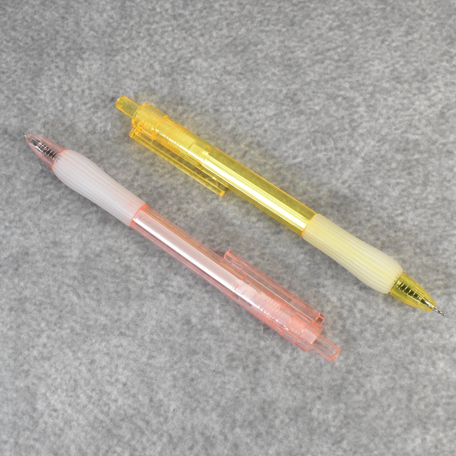 A pair of CustoPen ballpoint pens displayed with essential office stationery.