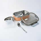 Lunch box featuring built-in spoon and adjustable divider