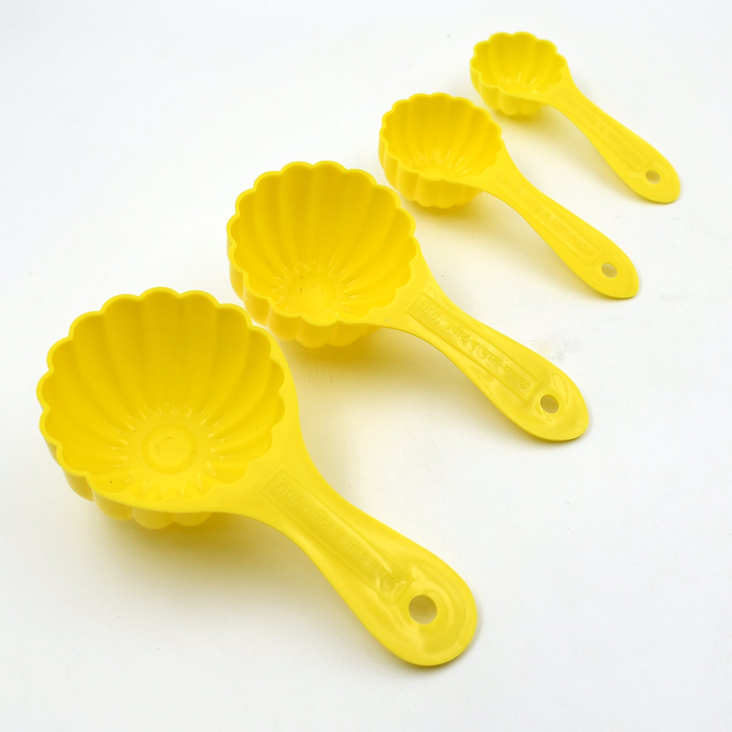 Four plastic ladoo moulds of varying sizes, showcasing their versatility for different sweets.