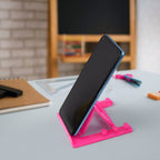 Sturdy plastic mobile phone stand supporting multiple smartphone sizes